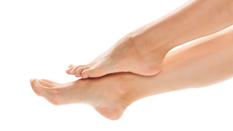 Beautiful women feet isolated on white close-up